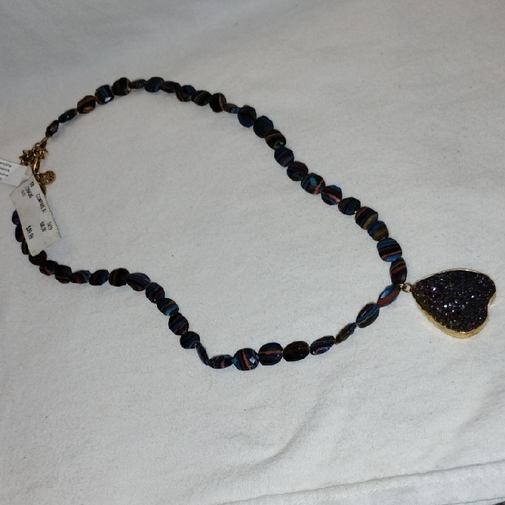 Beaded Necklace With A Black Heart Pendant With Blue, Purple And Gold Shimmers.